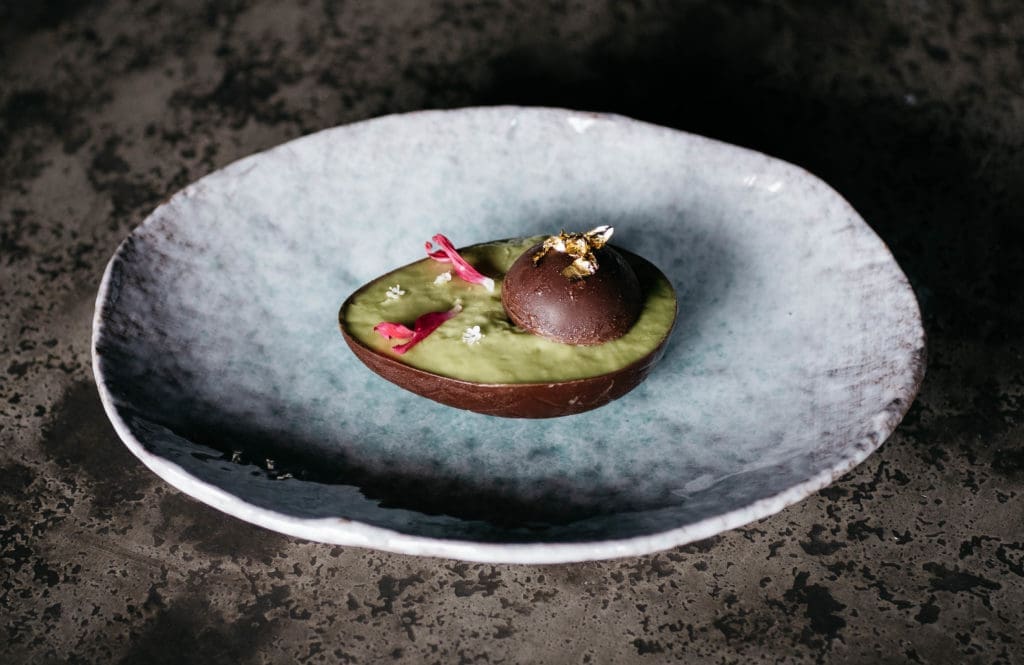 Each course is plated on custom ceramic dishes, and the food is meant to provoke conversation. (Photo by Caroline Fontenot)