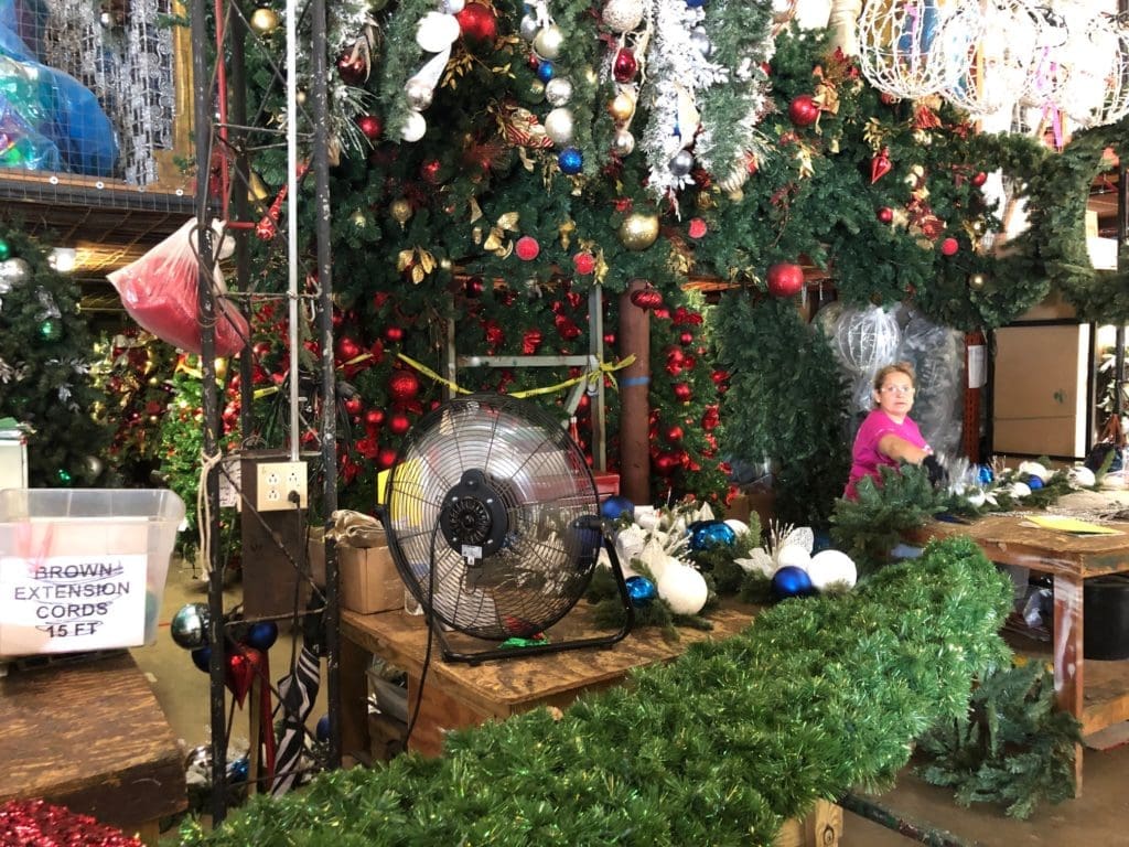 The warehouse is filled with artists working on trees, garlands, wreaths and other decor. (Photo by Shelby Hodge)