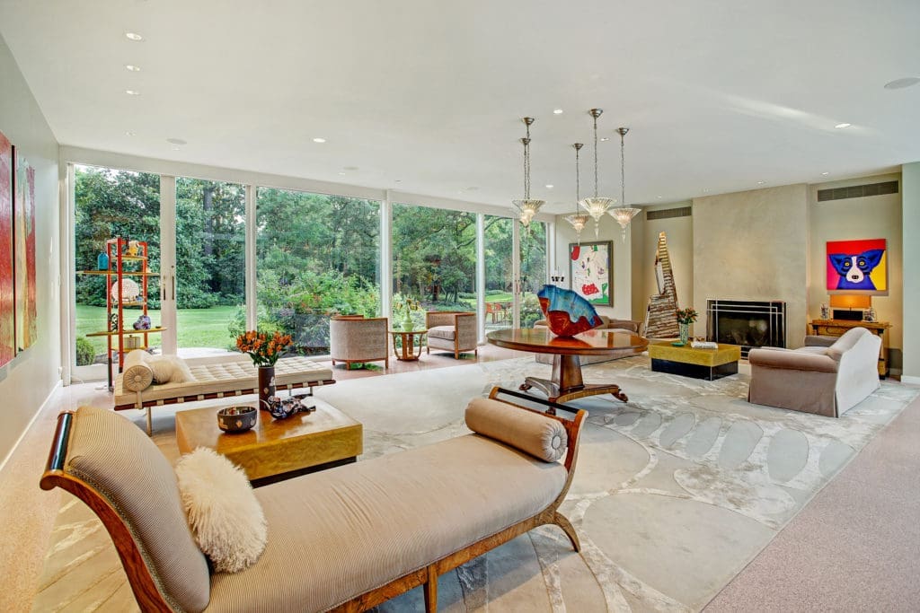 The living room offers unobstructed views into the lush gardens.  (Photo by TK Images)
