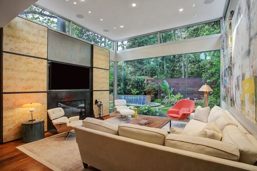 Light pours into the family room via glass walls. (Photo by TK Images)