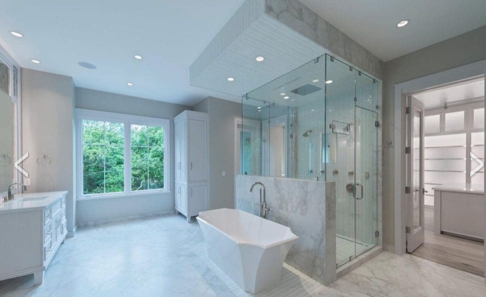 This master bath in a River Oaks home features furniture grade vanities and built-in cabinets, a large steam shower, dual water closets with bidets.