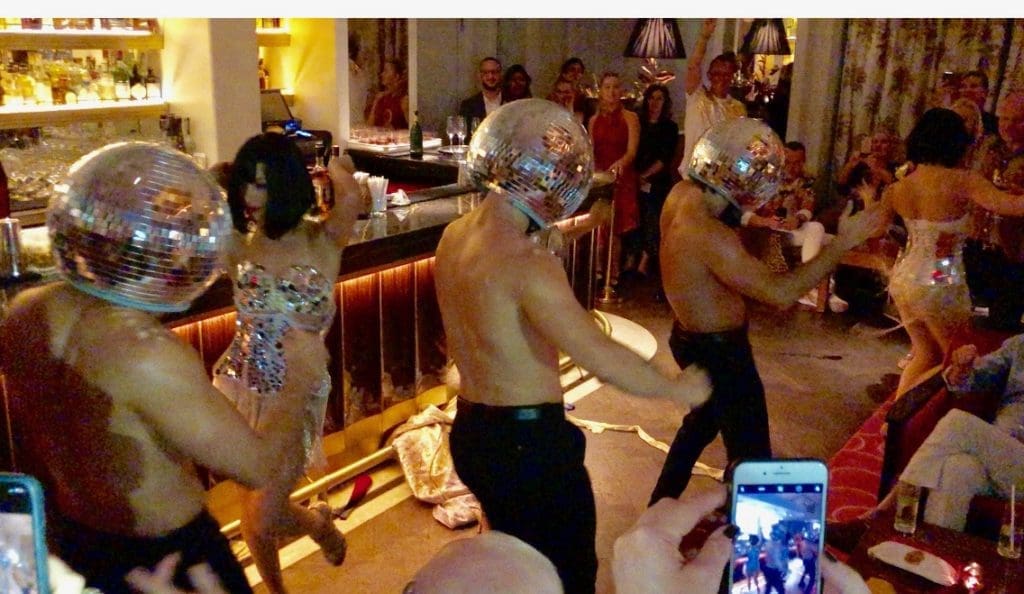 Geishas cum hotties and hunks with disco ball heads stir the birthday crowd at the Faena Hotel Miami Beach.