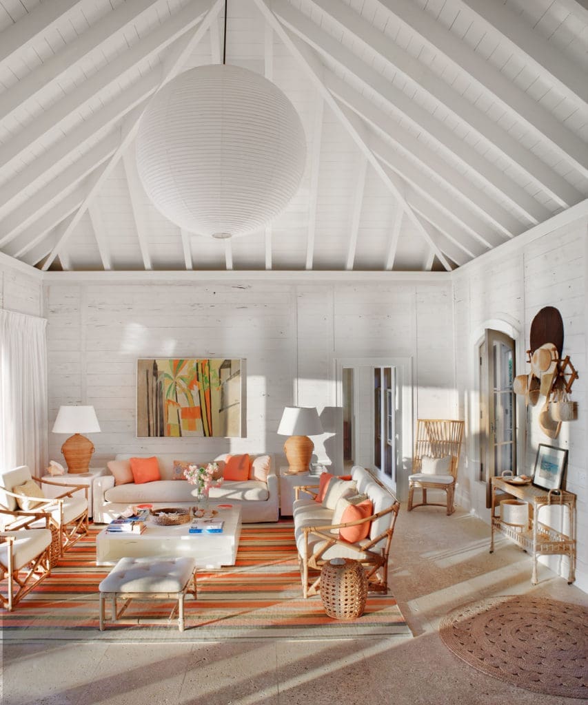 On a family compound on a barrier reef, the living area is paneled in whitewashed pecky cypress. Encaustic painting over sofa was  found in a Palm Beach shop.  (Photo by Francesco Lagnese)
