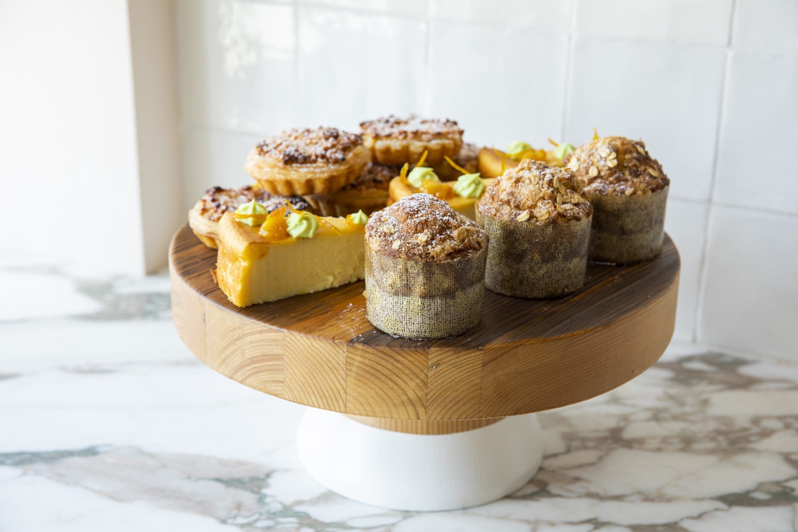 Back to front: Migliaccio (ricotta and semolina cake); Pastel De Nata (Portuguese egg tart); Pantxineta (Basque almond tart); Oat streusel muffin (Photo by Julie Soefer)