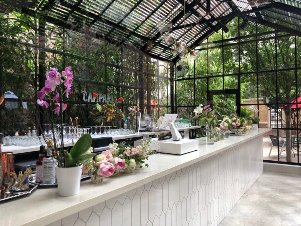 Sip drinks at Bravery Chef Hall's incredible Secret Garden Coffee & Cocktails.