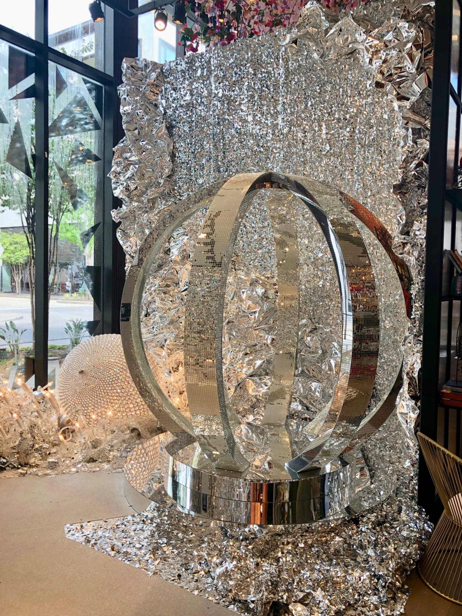 The larger-than-life disco ball is centerpiece of the 'Bring the House Down' installation where chandeliers have 'crashed' to the floor. (Photo by Shelby Hodge)