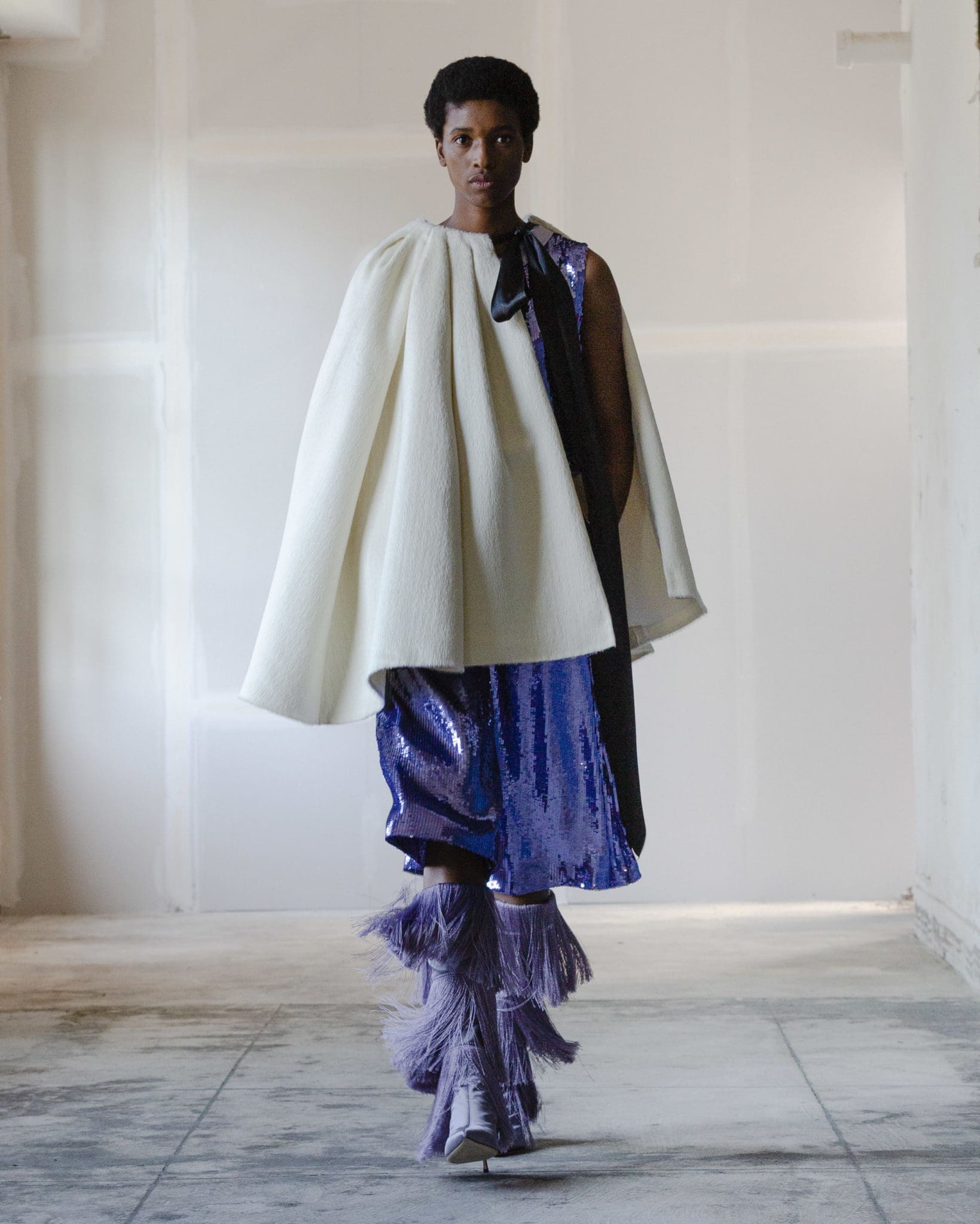 Adam Lippes purple sequin top and culotte, ivory alpaca cape, lilac silk fringe boot. (Photo courtesy of Adam Lippes)