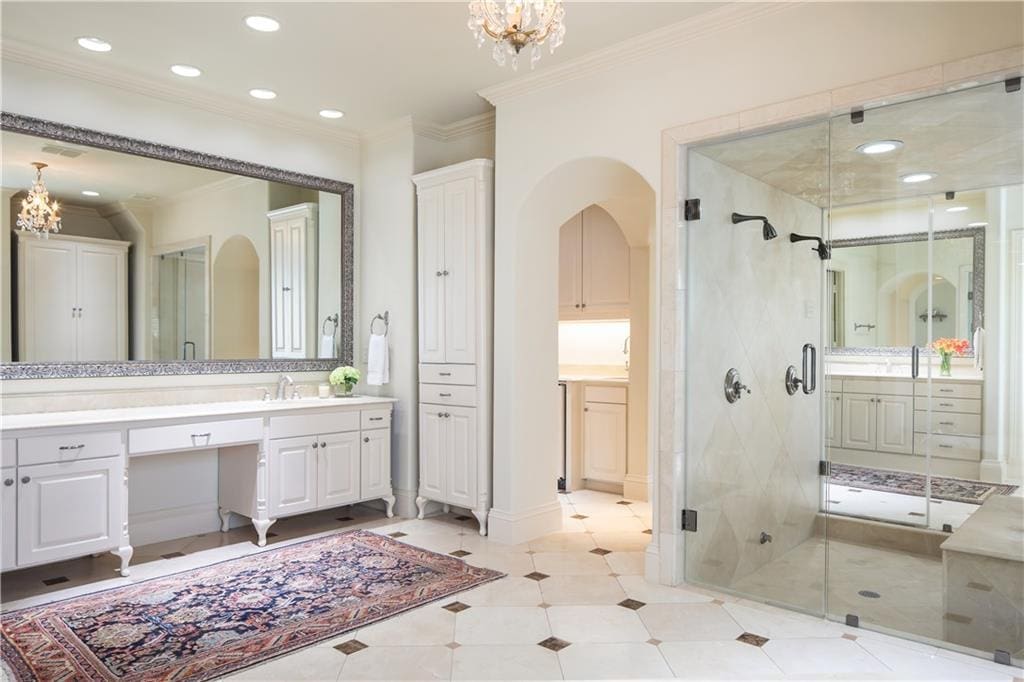 The master bath boasts his and hers closets and vanities. 