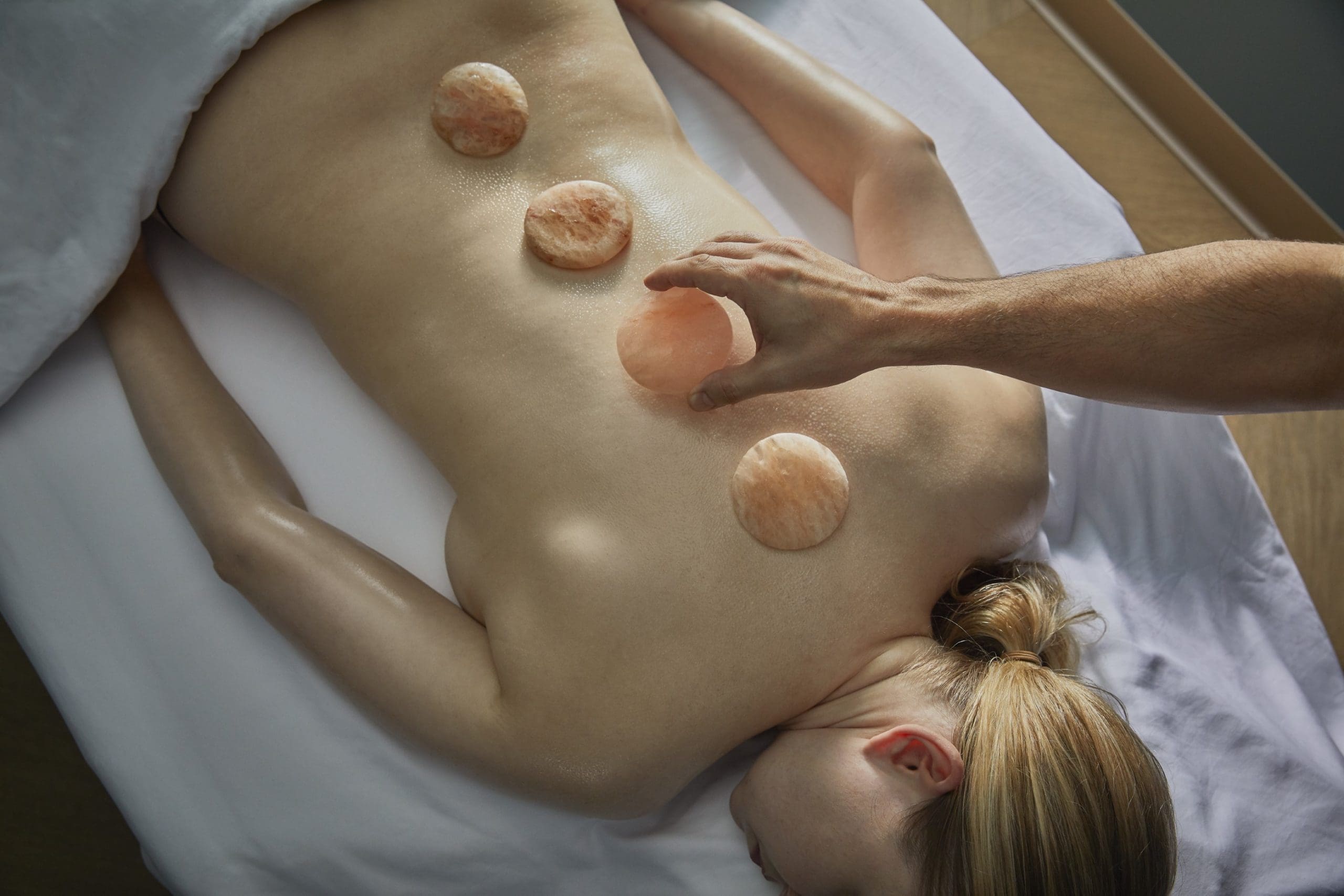 Salt stones are carefully placed in a treatment at Bergamos Retreat.