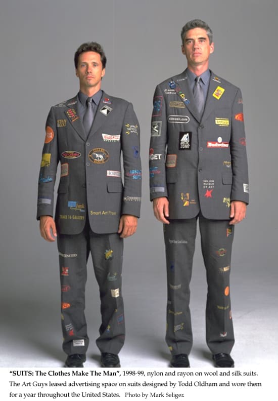 The Art Guys received a Times Square parade for "Suits: The Clothes Make the Man." The 1998-1999 performative project featured snappy Todd Oldham- designed suits emblazoned with ads. As such, the iconic artwork offered a brilliant critic of fashion, consumerism, and the art world's courting of mega brands and big money. (Courtesy The Art Guys) 