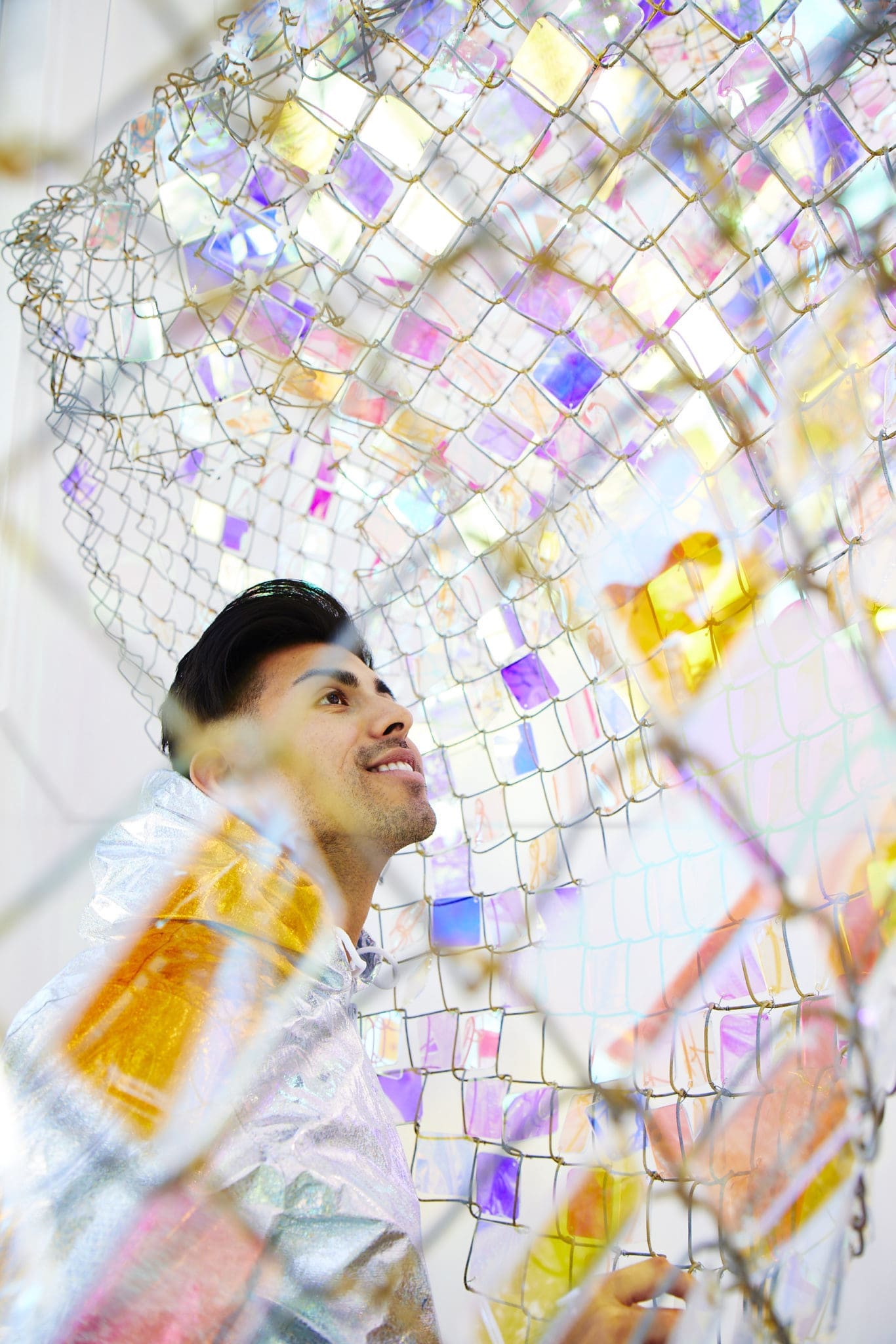 "Unwoven Light," made of chain-link fence and iridescent crystal squares, changes colors according to the natural light. (Photo by Cody Bess)
