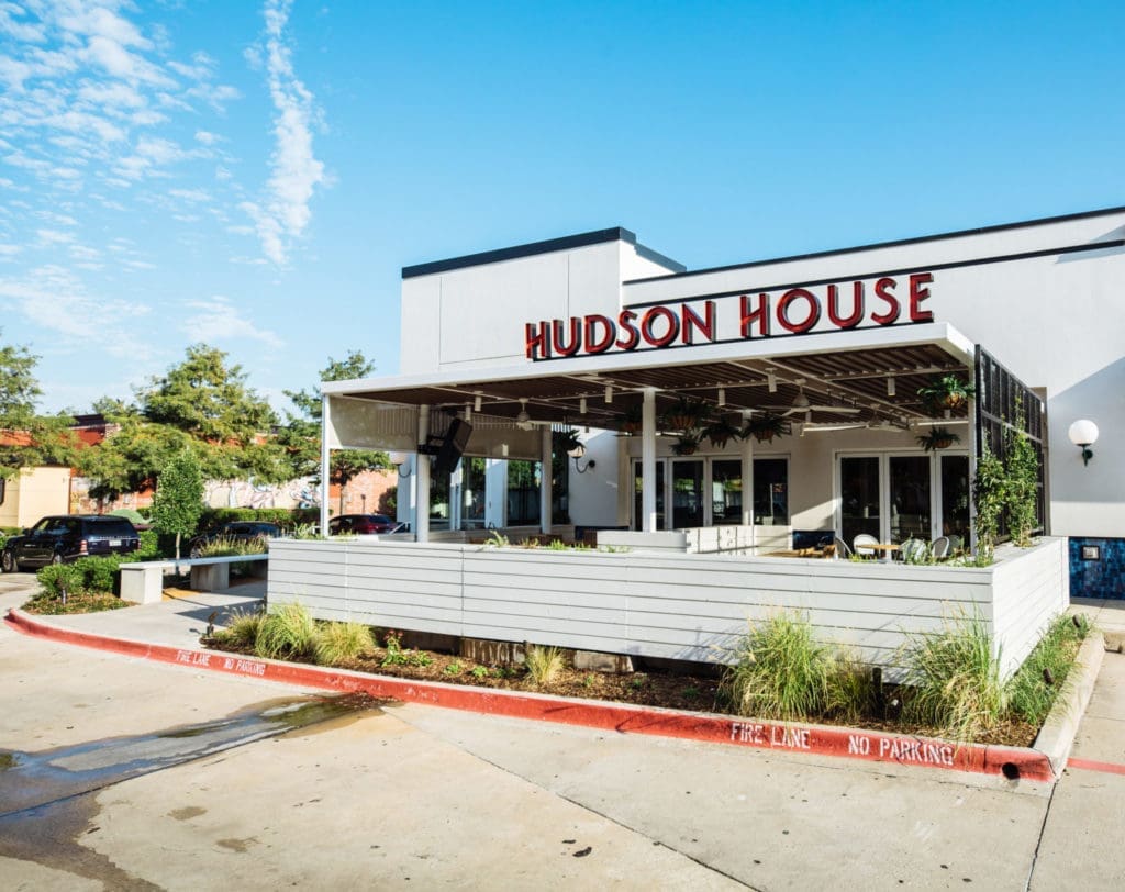 The charming facade to the Hudson House Addison with its lovely patio.