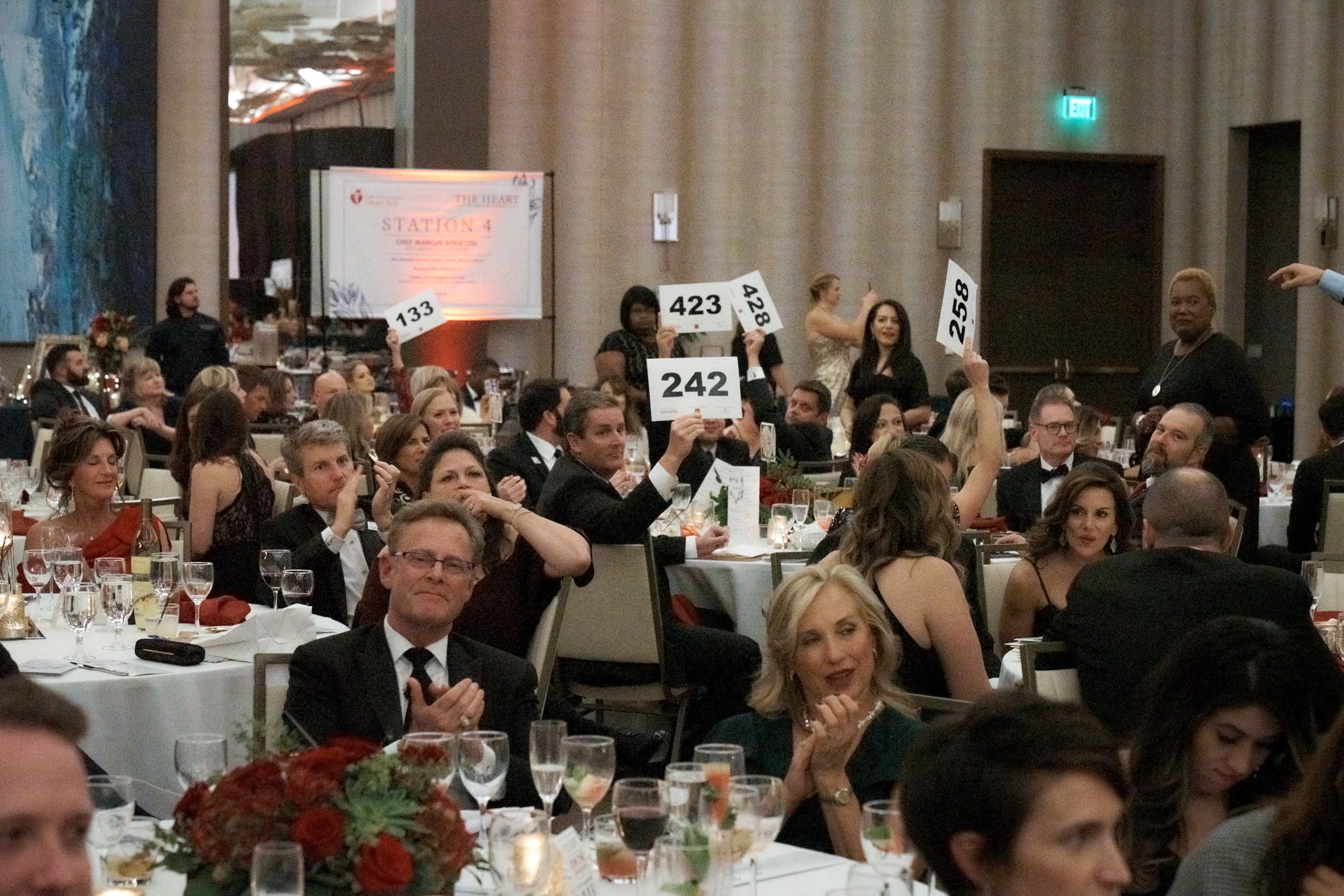Guests excitedly bid on once-in-a-lifetime experiences.