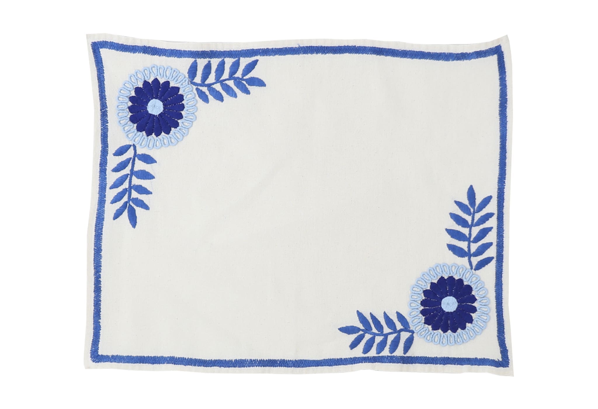 Mantel de Aguacatenango Azul hand-embroidered in Mexico with blue floral and vine designs on ivory linen.