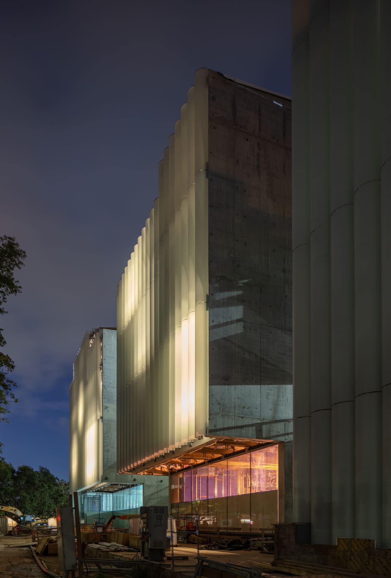 Diffused light glows from the glass tubing on the east facade of the MFAH Nancy and Rich Kinder Building, providing a contrasting serene element to the structure's  robust muscular stance. (Photo © Richard Barnes)