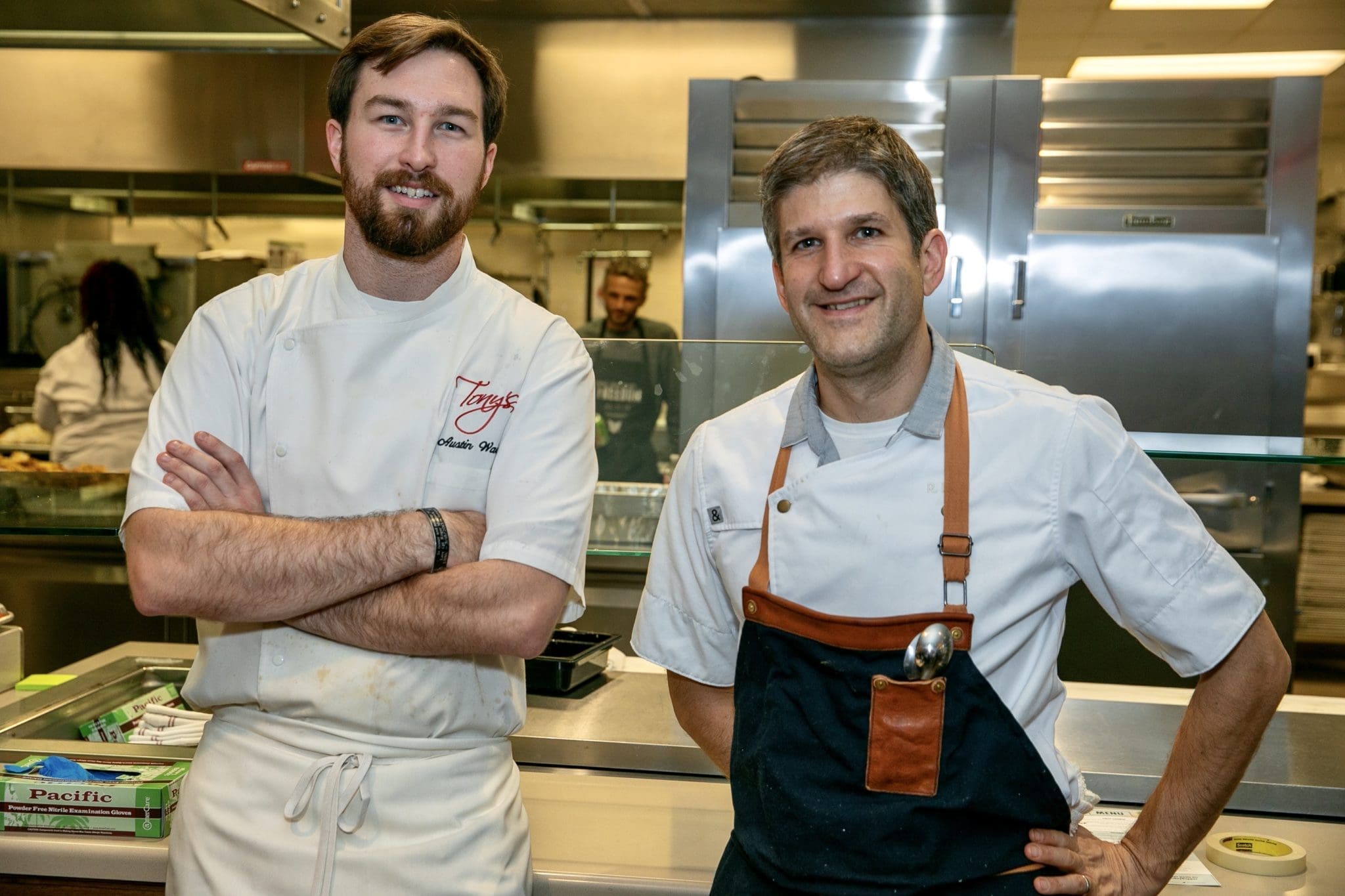 Tony's executive chef Austin Waiter and a friend cooking at the November 2019 Urban Harvest Sunday Supper at St. John's School. Waiter has the lead in the May fundraiser. (Photo by Emily Jaschke)