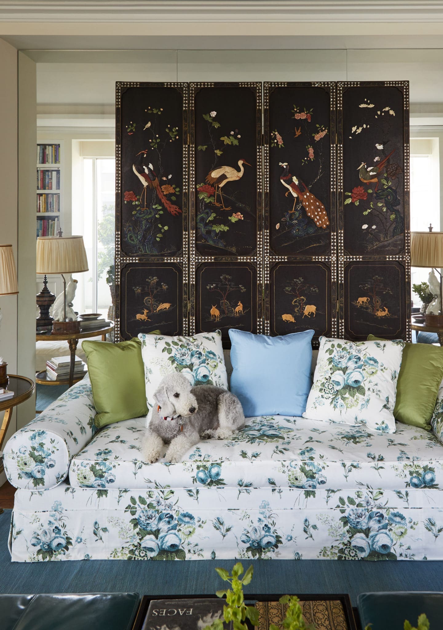 The lacquer screen was in Fine's childhood home and brought from China in the 1950s by her uncle. GoGo sits on a sofa covered in Lisa Fine Textiles from James showroom.