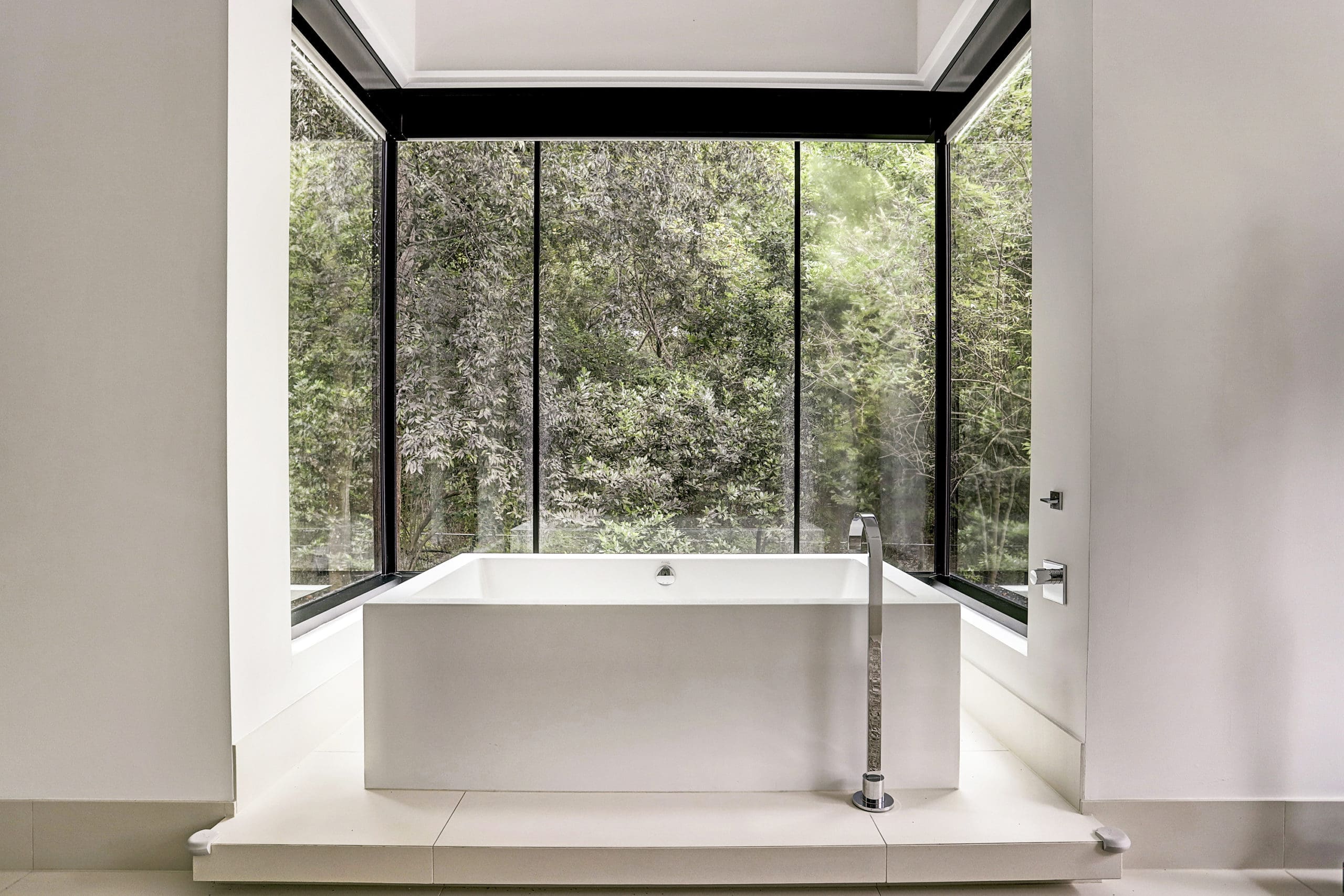 A contemporary soaking tub with a view in the master bath. (Photo by TK Images)