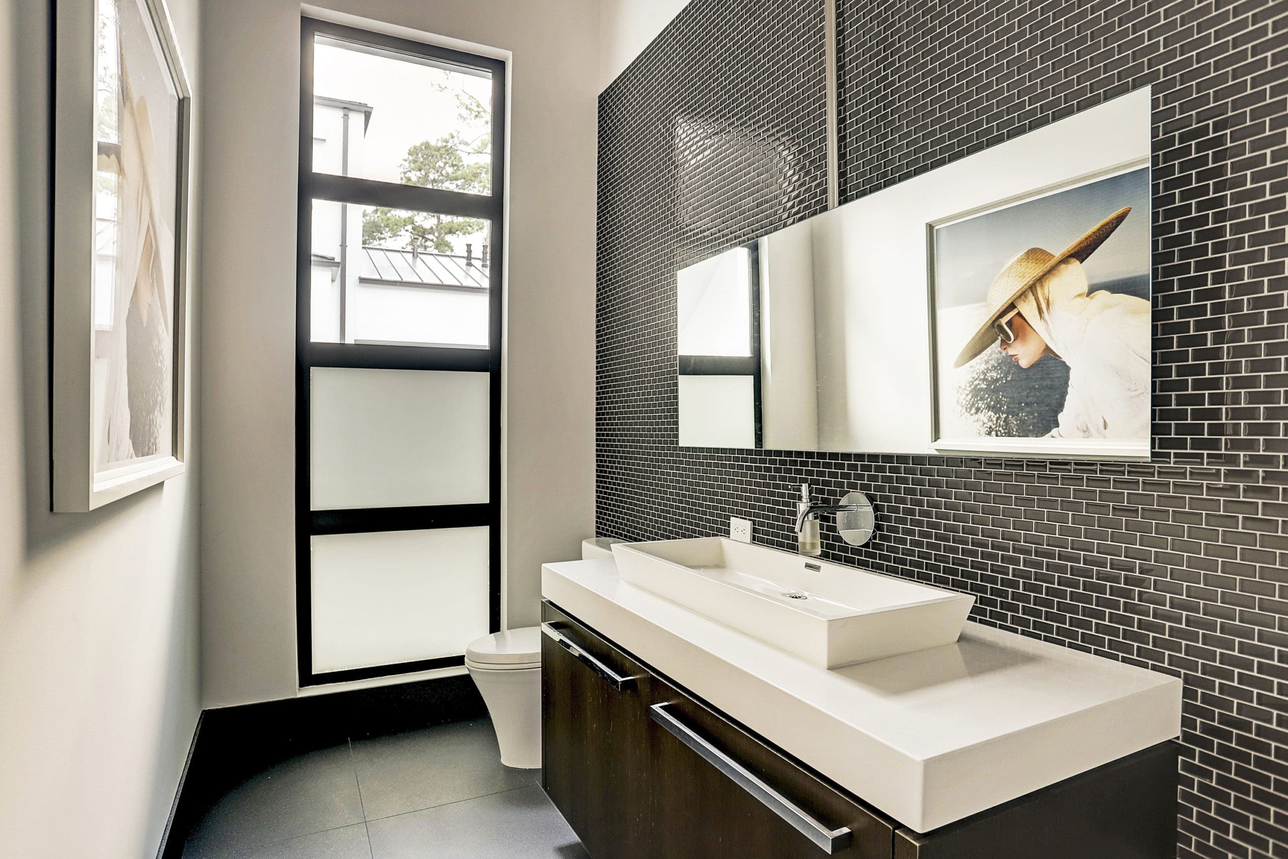 The pool bath features tilework and an oversized vanity with absolute white okite countertop and vessel.  (Photo by TK Images)
