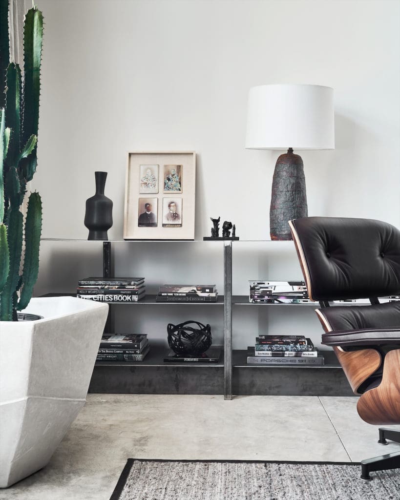 Eames lounge chair. Raw-steel shelves of Chad Dorsey’s design. Vintage lamp. (Photo by Stephen Karlisch)