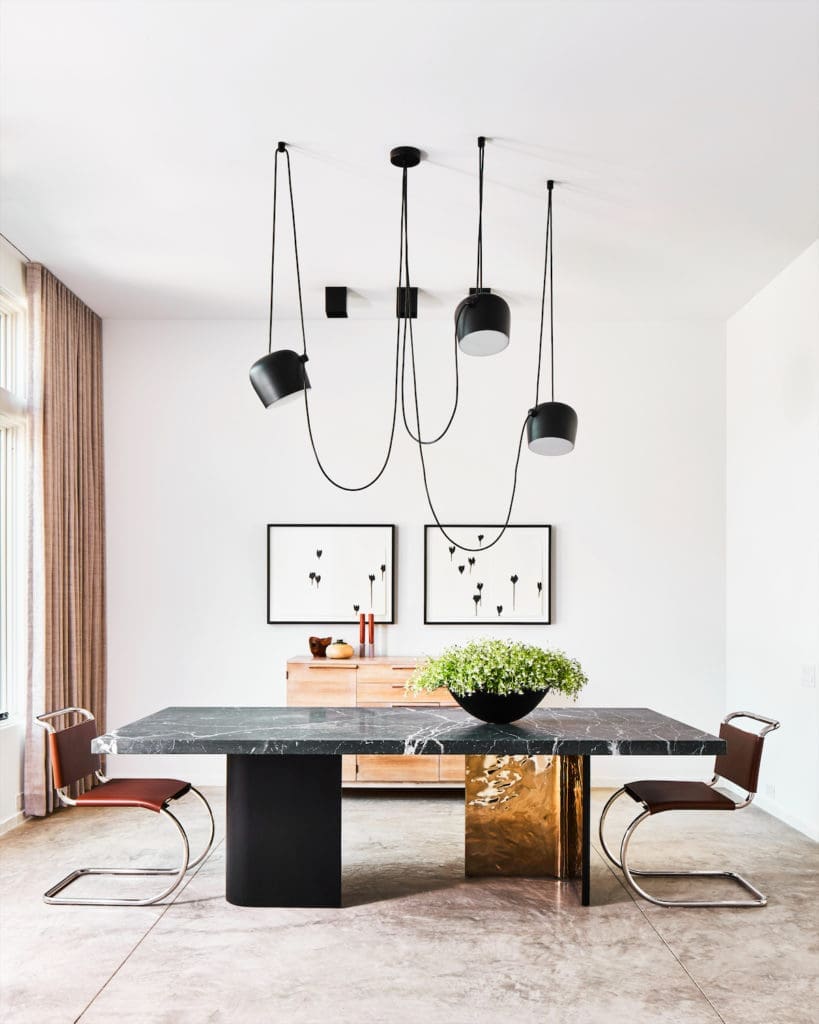 In the dining room, the Kara Mann-designed table for Milling Road at Baker was customized with a marble top designed by Chad Dorsey. (Photo by Stephen Karlisch)