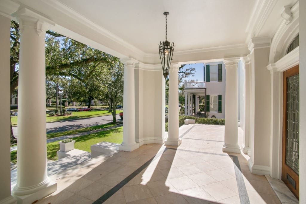 A sweeping front porch welcomes guests to 18  Audubon Place.
