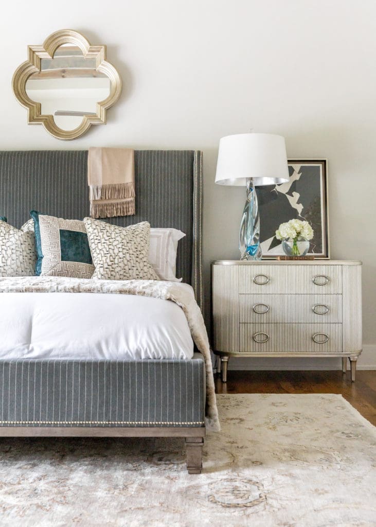 The custom bed by Wesley Hall is focal point of the master bedroom that features a Kensington rug by Loloi. (Photo by Jen Burner)