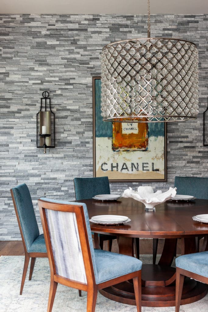 The mood of the formal dining room chairs and expandable table in walnut finish is lightened by the hand-knot traditional rug.  (Photo by Jen Burner)