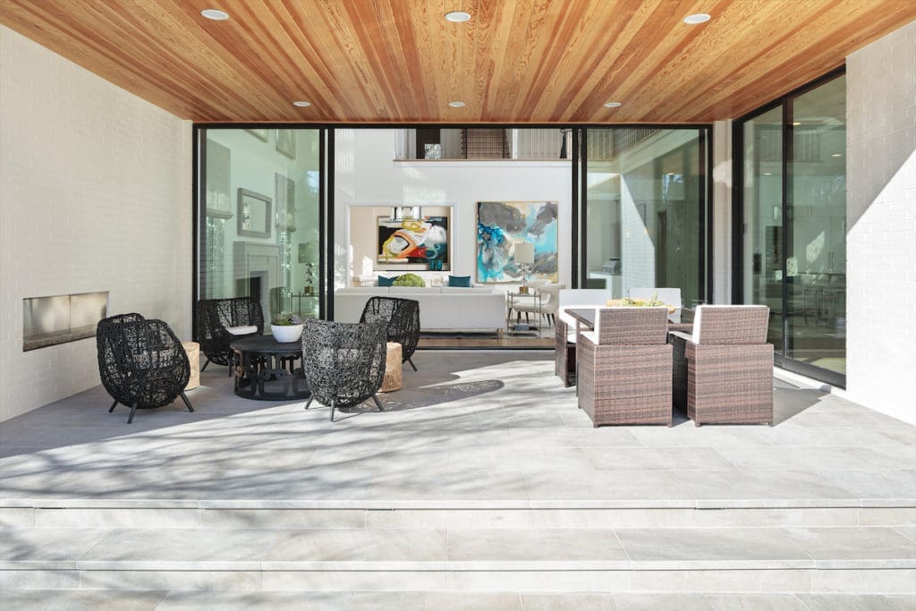 The outdoor living area can be easily heated and cooled, and includes a fireplace and a full kitchen and bar setup by Lynx.