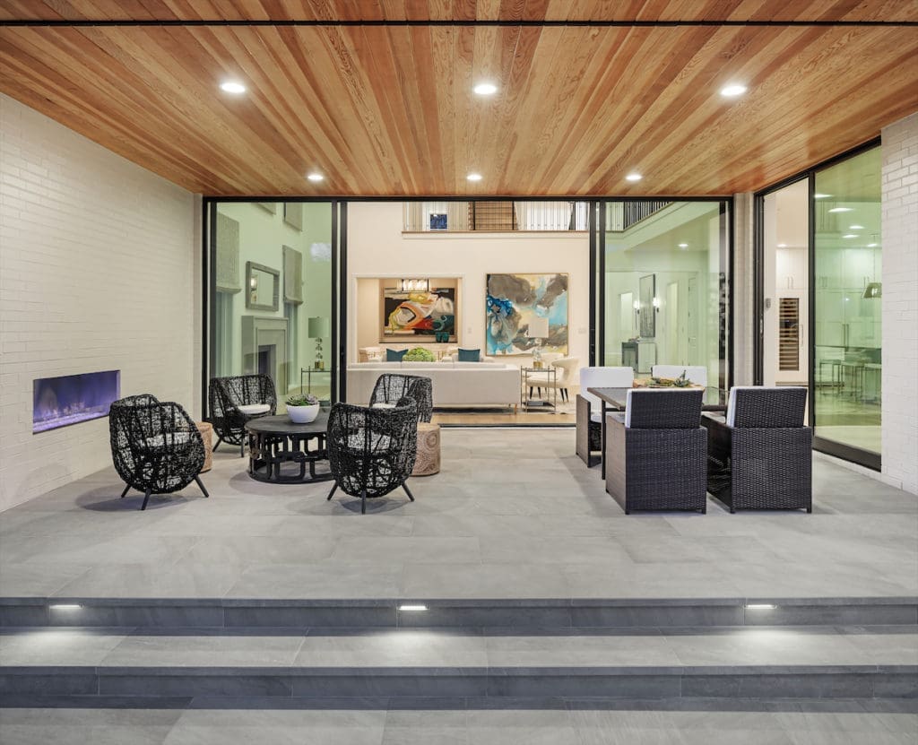 The outdoor living area can be easily heated and cooled, and includes a fireplace and a full kitchen and bar setup by Lynx.