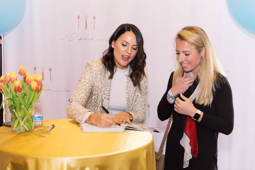 Alex Snodgrass signing her new cookbook at the Tri Delta Philanthropies' fundraiser, The Sale. (Photo by Parker Chase Photography)