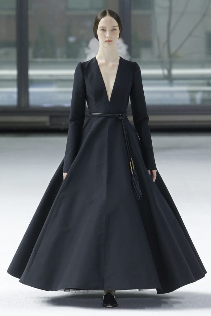 Carolina Herrera black silk faille V-neck long sleeve A-line dress, black lace-up brogue, black tubular belt. (Photo courtesy of Carolina Herrera)