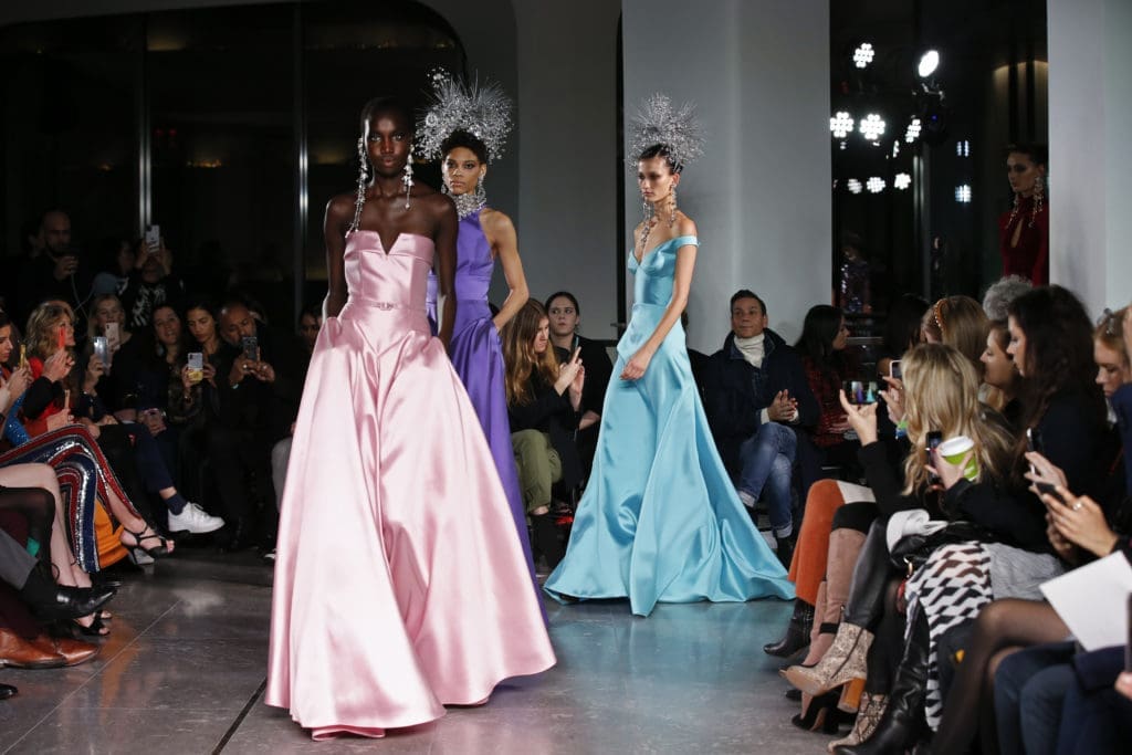 Naeem Khan closed his runway show with a series of satin gowns and Statue of Liberty headdresses. (Photo by Dan and Corina Lecca)