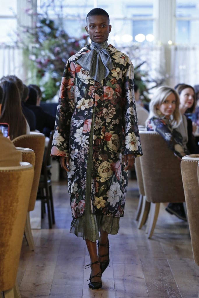 Adam Lippes "Rohuna" floral silk and and metallic jacquard hooded coat, grey chevron silk twill bow blouse, grey chevron silk twill and chiffon pieced and pleated skirt. (Photo by Dan Lecca)