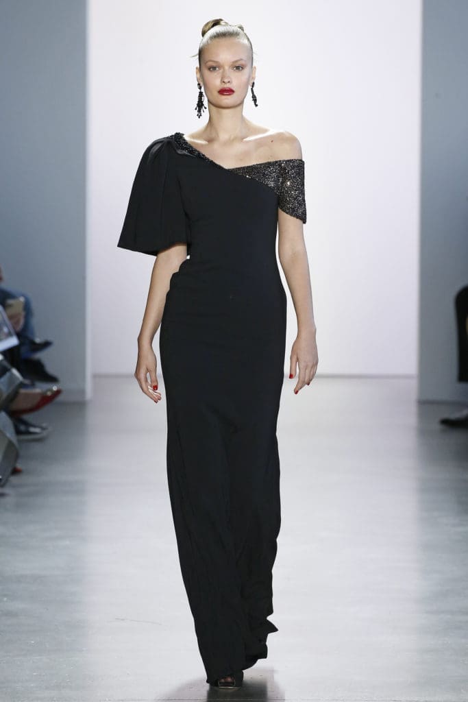 Badgley Mischka black gown with asymmetrical neckline and just a dusting of black sequins at the shoulders affirms the notion that sometimes simplicity is best. (Photo courtesy of Badgley Mischka)