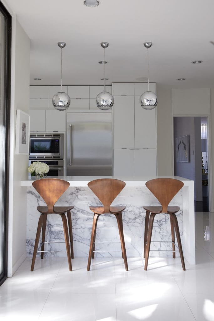 In the kitchen, Cherner counter stools from Design Within Reach. Tom Dixon Mirror Ball pendants. (Photo by Pär Bengtsson)