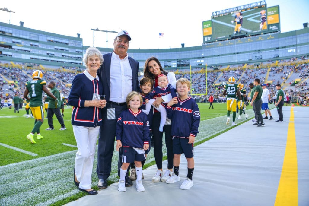 Janice McNair and Cal & Hannah McNair, enjoying a family moment on the sidelines, will helm the inaugural Houston Texans Season Premiere dinner. (Photo by Michelle Watson, CatchlightGroup.com)