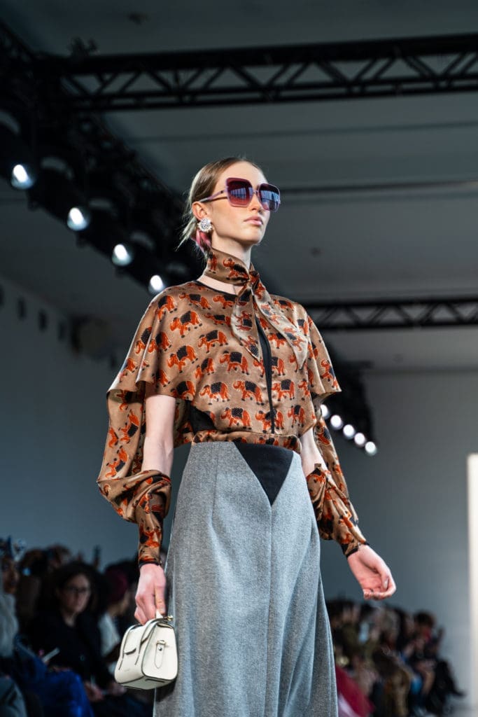 Bibhu Mohapatra rust organic silk block print winged top with ash wollen cashmere four panel skirt. (Photo by Anna Vivare)