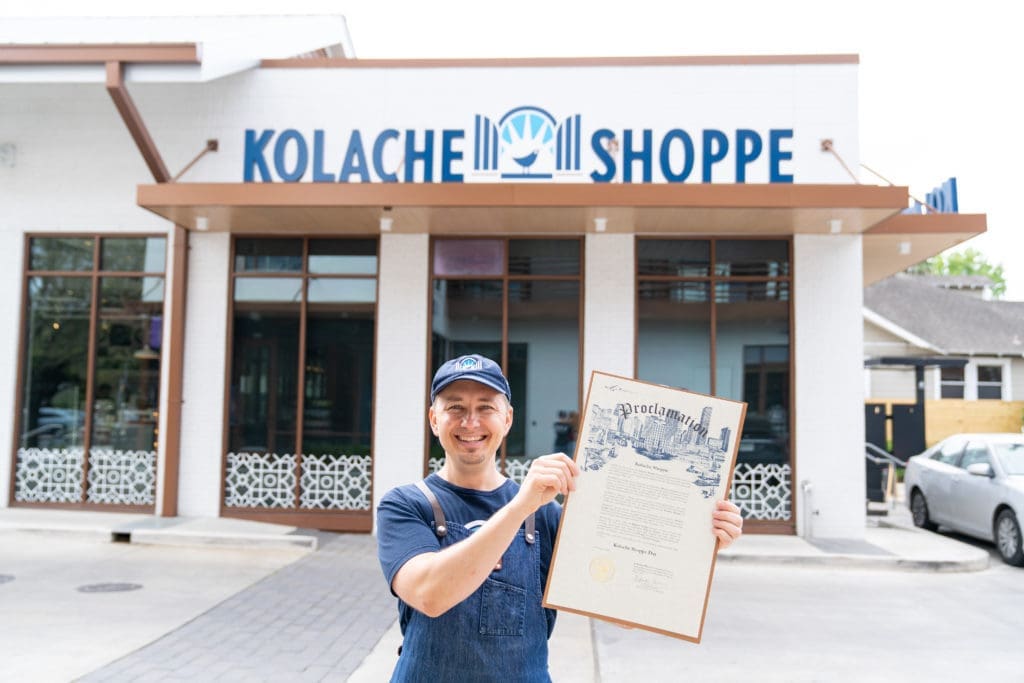 Randy Hines shows off the Mayor's proclamation declaring April 1 as  Kolache Shoppe Day in Houston.  (Photo by Carla Gomez)