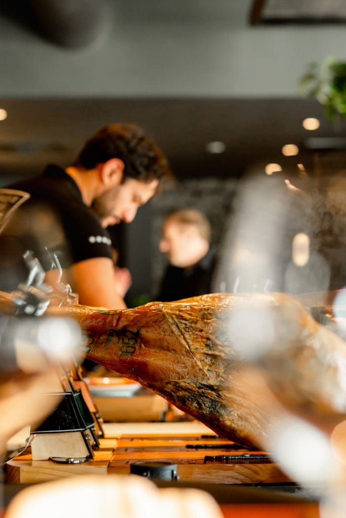 At Enrique Tomás, whole jamóns can be seen through the window.