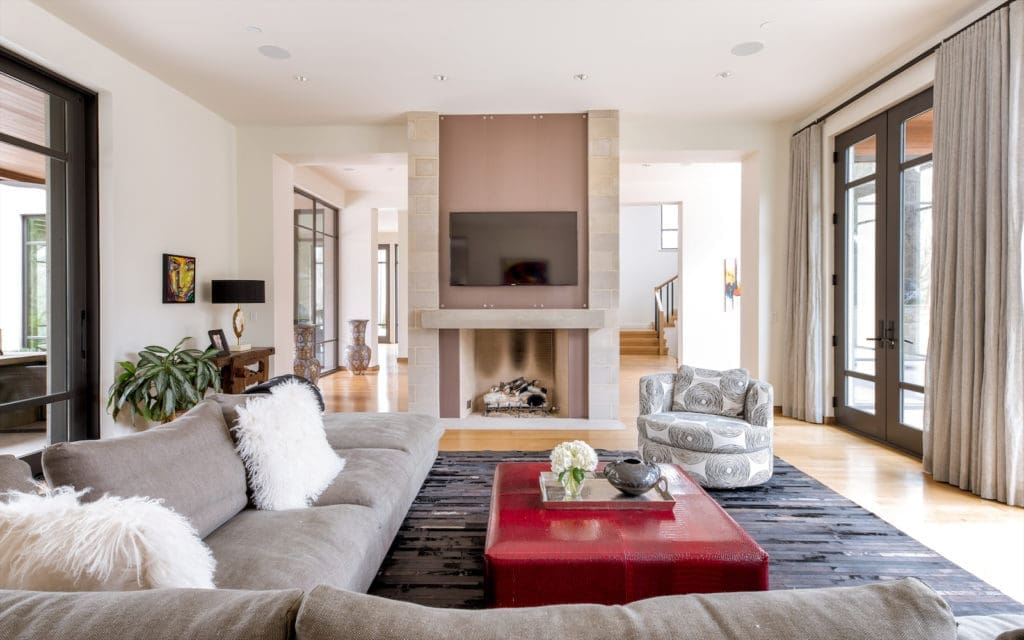 It’s a beautiful, sun-soaked space with dramatic vaulted ceilings, attractive light fixtures, and warm-hued materials that make this new build feel instantly like home.