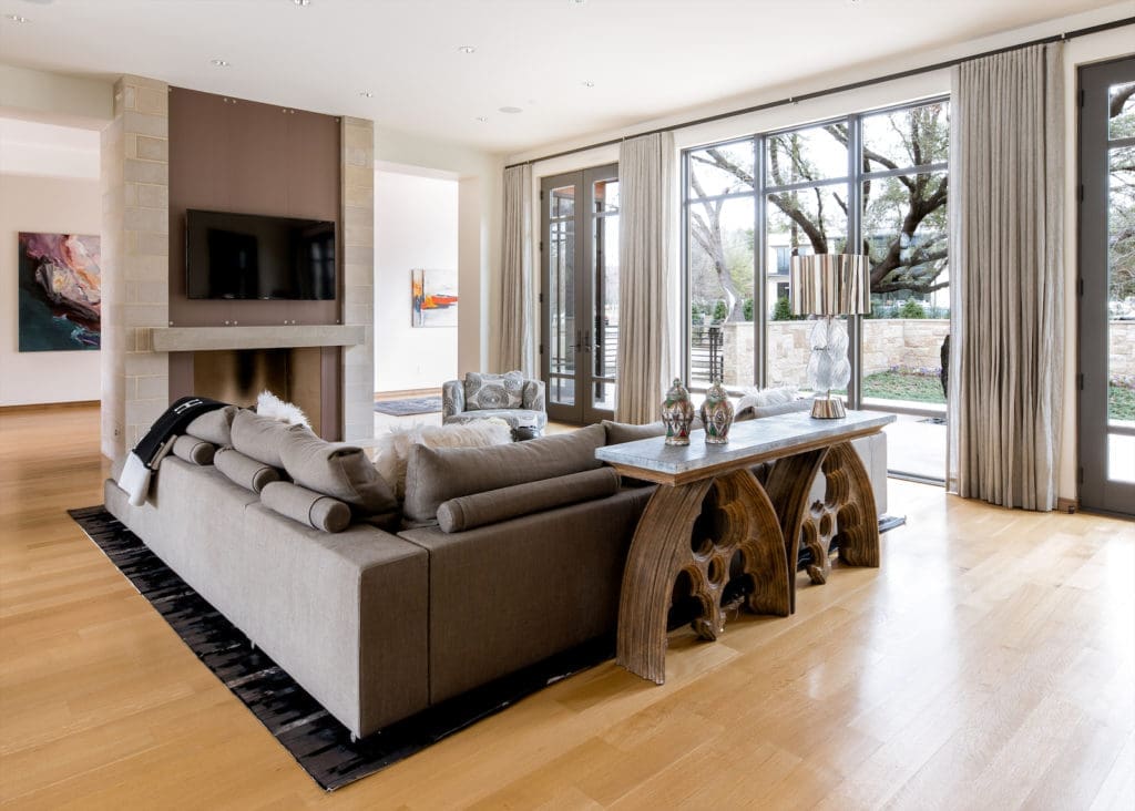 It’s a beautiful, sun-soaked space with dramatic vaulted ceilings, attractive light fixtures, and warm-hued materials that make this new build feel instantly like home.
