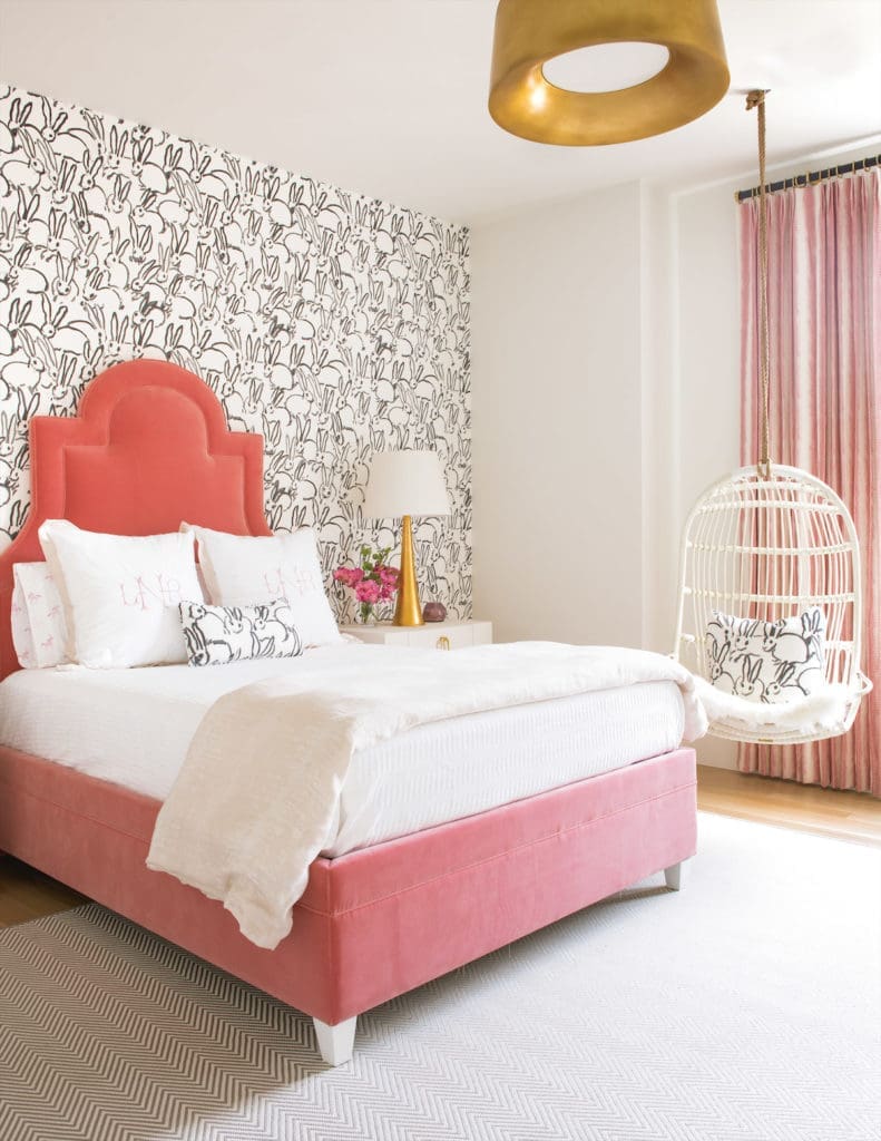 In this Preston Hollow home, designed by Philip Thomas Vanderford and Jennifer Klos, the guest bedroom's Hunt Slonem bunnies delivers a whimsical spirit. (Photo by Costa Christ Media)