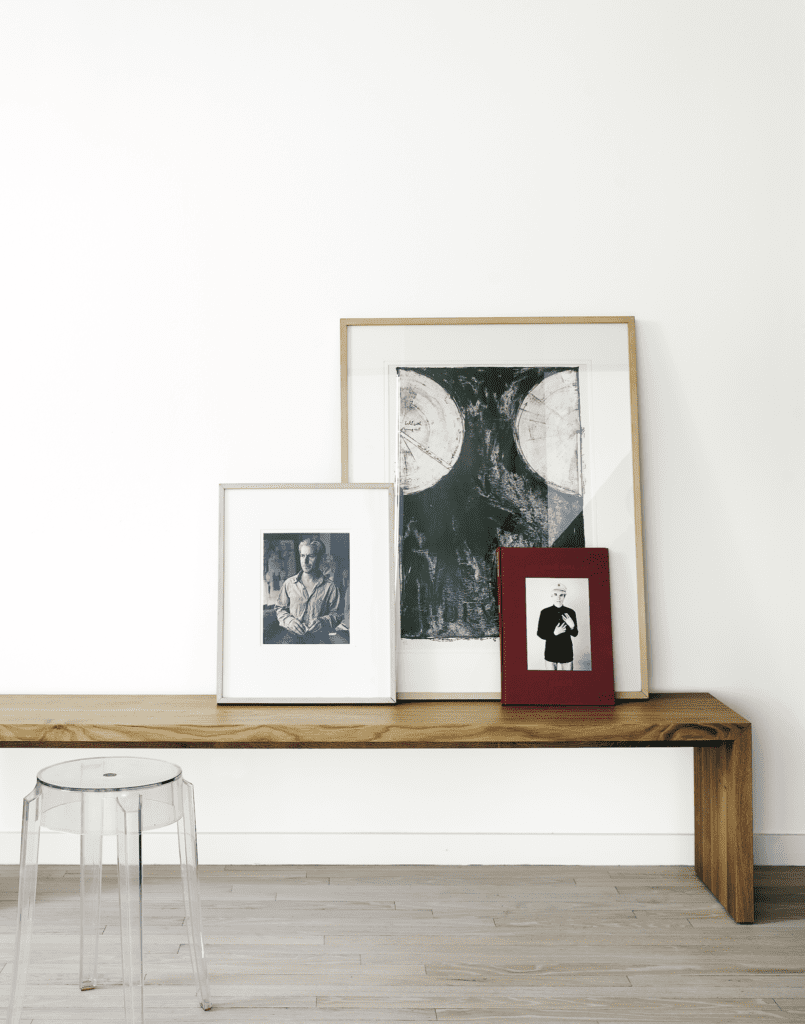 Barbara Davis, published April 2016. Photographed by Casey Dunn. In gallerist Barbara Davis' high-rise home, carefully edited furniture placed in dialogue with works of art. Ligne Roset Eaton bench. Philippe Stark Charles Ghost stool, from Sunset Settings. Art, from left: William de Kooning, 1980s; Jasper Johns print; Andy Warhol book. 