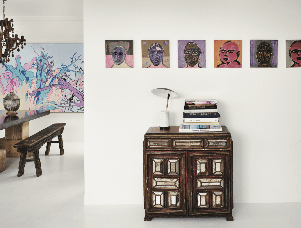 Garrett Hunter, published September 2016. Photographed by Casey Dunn. In designer Garrett Hunter’s high-rise home at The Regency House, an antique mirrored Mexican chest and marble-and-brass lamp. Untitled abstract portraits by Sergio Zenteno, circa 1980, from Dermot Begley, L.A. 