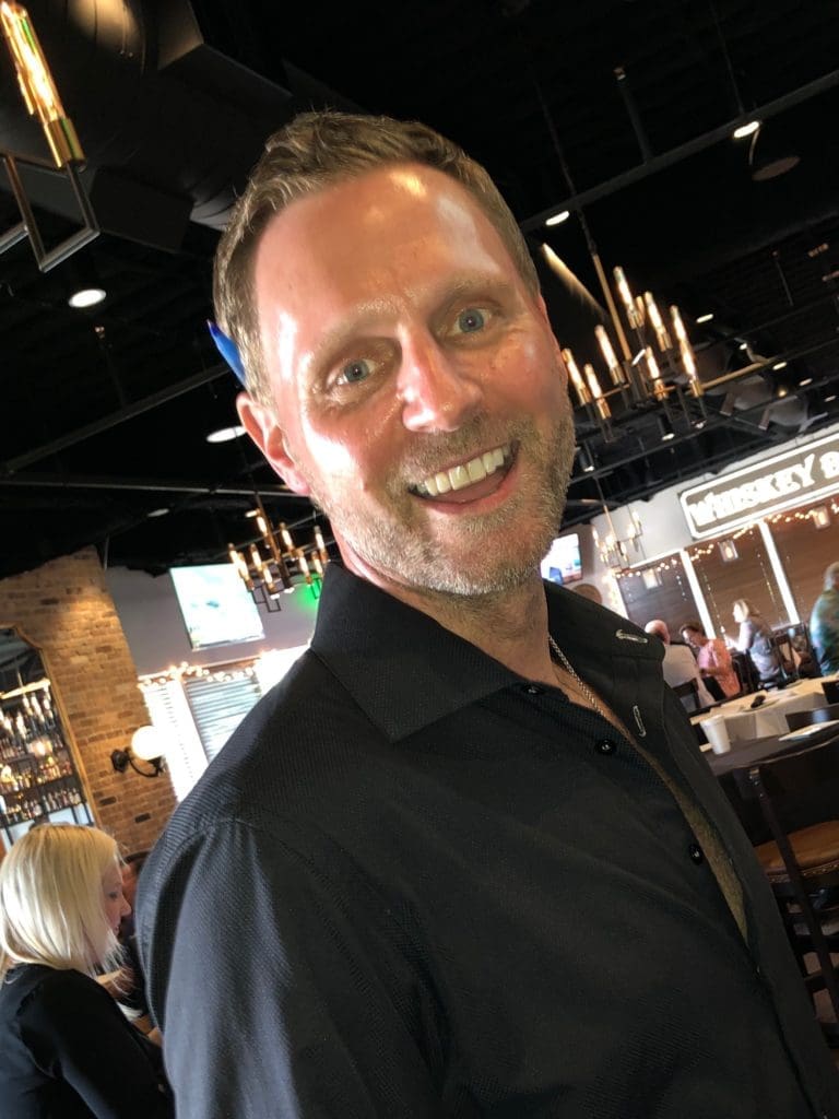 Matt Brice all smiles at the reopening of his Federal American Grill on the Katy Freeway, despite county orders to the contrary. (Photo by Judy Nichols)