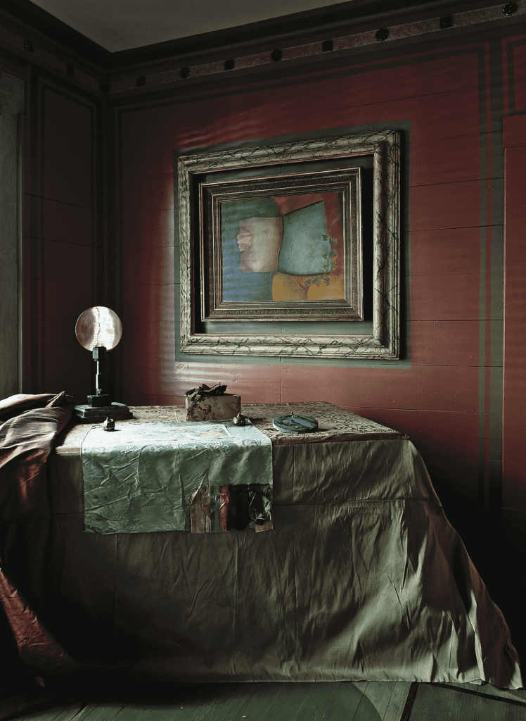Salle Werner-Vaughn, published September 2012. Photographed by Jenny Antill and Jack Thompson. Artist Salle Werner-Vaughn’s magical 100-year-old cottage, called The Palace by the Way, is one of a cluster of five bungalows titled Harmonium, which Werner-Vaughn has tended to for more than 25 years. A lavish bolt of silk acquired from friend Carol Isaak Barden and a square of sample damask left to her by a favorite upholsterer. Mirror sculpture is by Werner-Vaughn, as is the painting, "Within," 1967.