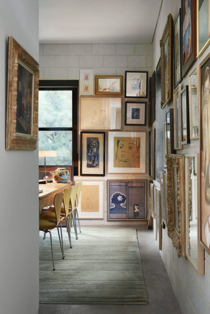 Artwork created by owners James Ferrara and real estate tycoon David Griffin is hung gallery-style in their Oak Cliff library.  (photo by Lisa Petrole) 