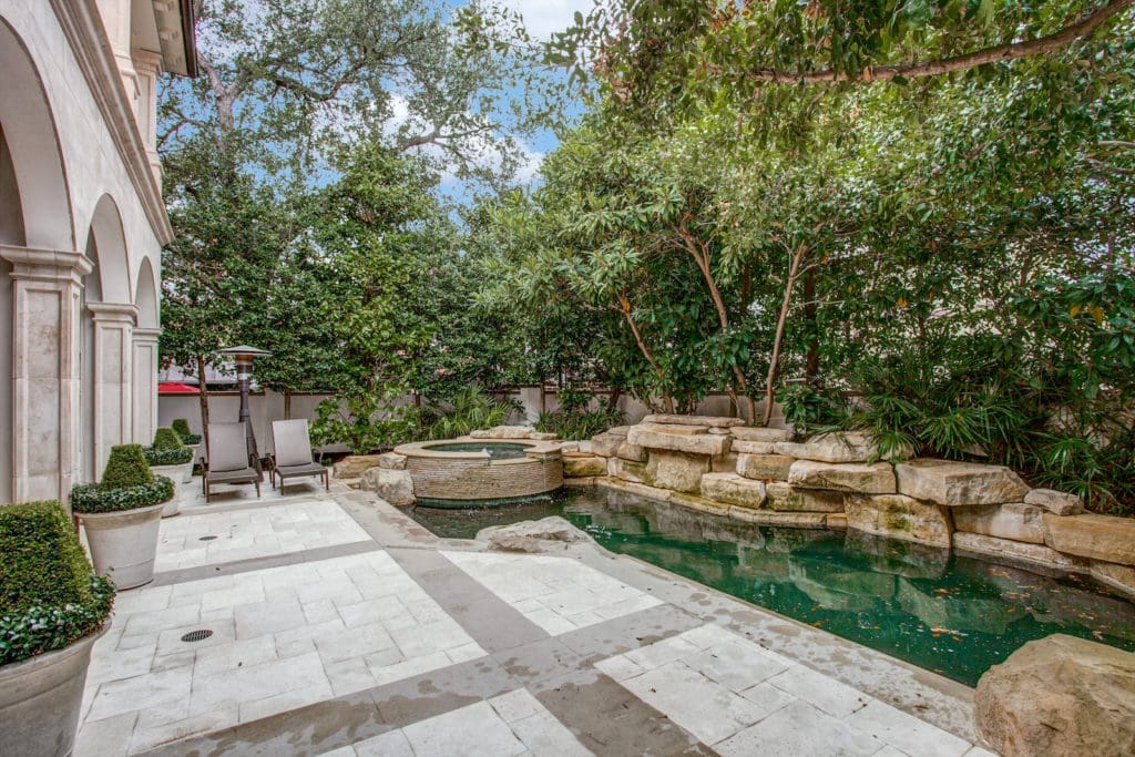 A lushly landscaped private pool area and hot tub. (Photo by Compass Real Estate)