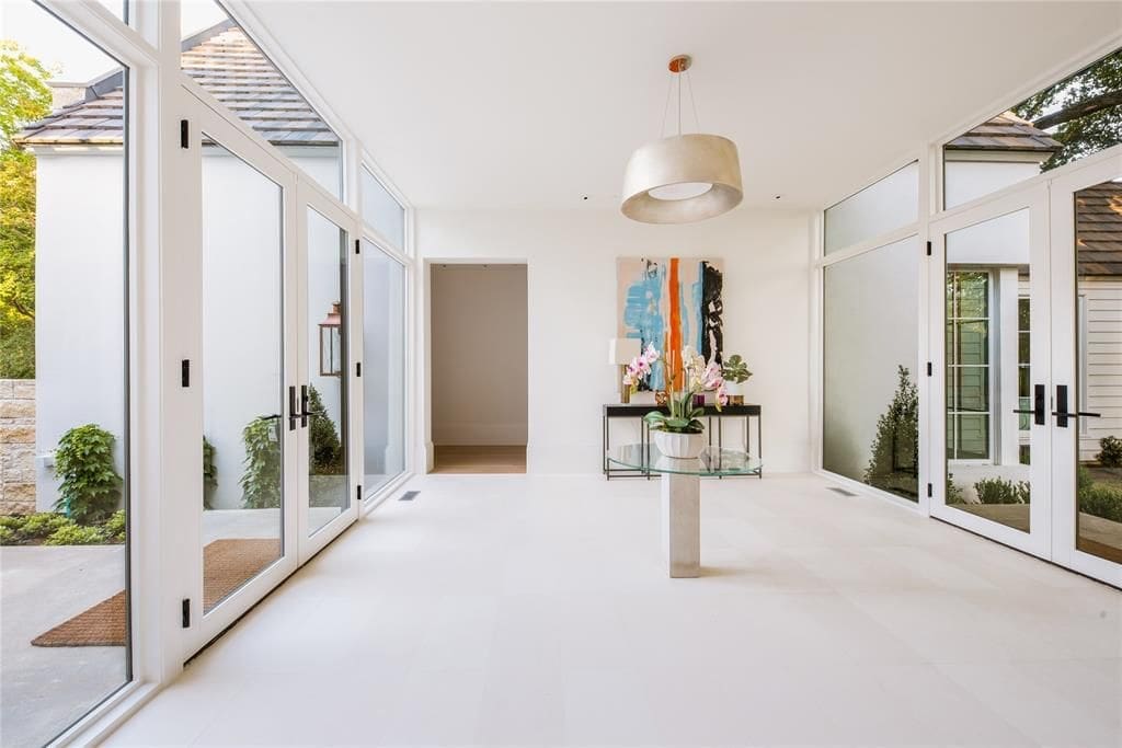 An easy-on-the-eyes blend of natural materials and an excess of natural light help keep the outdoors in. (Photo by Compass Real Estate)